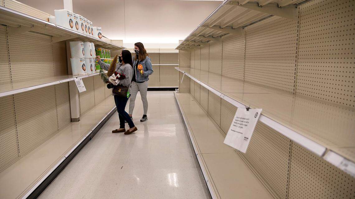 Nereida Yanez and Madison Jones shop for toilet paper from nearly empty shelves at Target on Fulton Avenue on Thursday, Nov 19, 2020, in Sacramento. Customers are able to purchase one package of toilet paper or paper towels at a time.