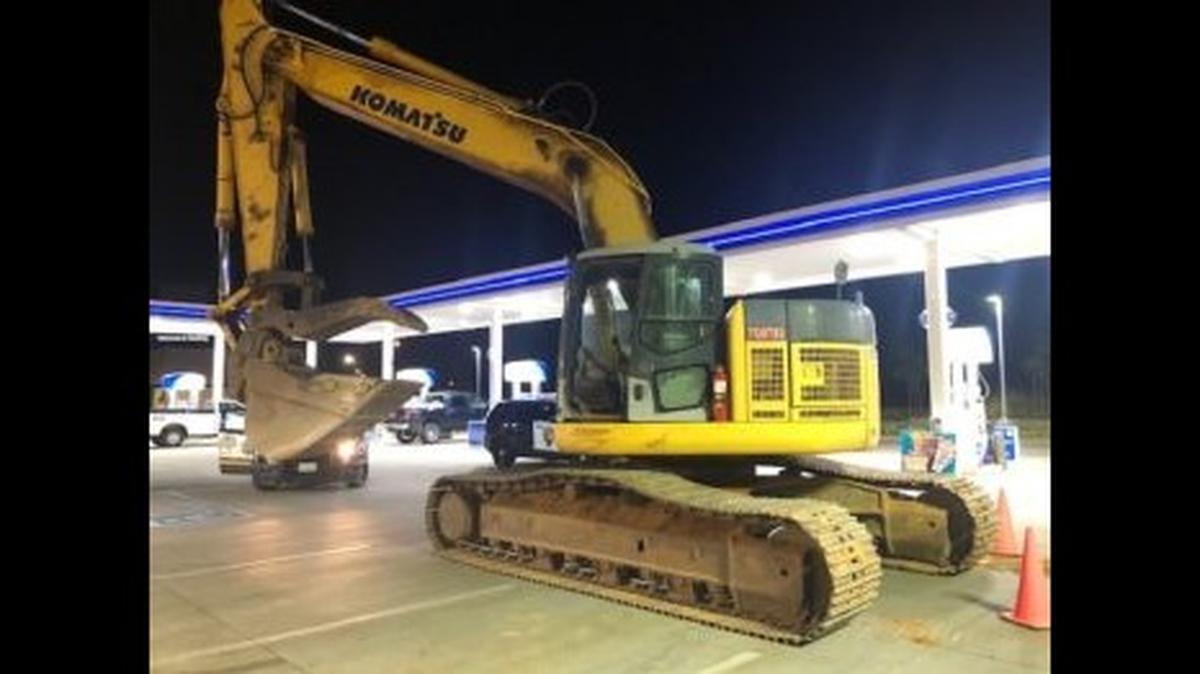 A man allegedly stole a large construction excavator from an I-5 on-ramp in Redding and drove it into the overhang of an Arco gas station.