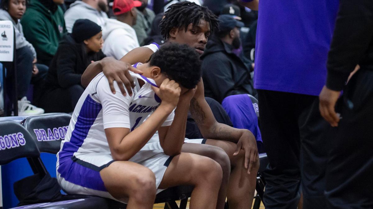 The Sacramento Dragons’ Shabol Barksdale (10) consoles guard Bobby Hamilton (1) after the loss against the California Grizzlies in the first round of the CIF Northern California Division II regional playoffs on Tuesday at Sacramento High School. The Grizzlies won 69-63.
