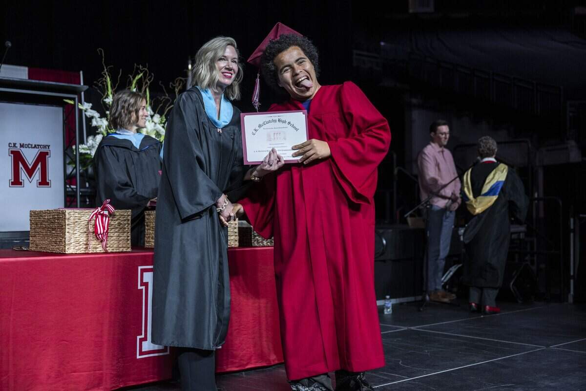 Alijah Smith, a C.K. McClatchy High School graduate, reacts for the camera as he receives his diploma from Principal Andrea Egan at Golden 1 Center on Monday, June 8, 2026.