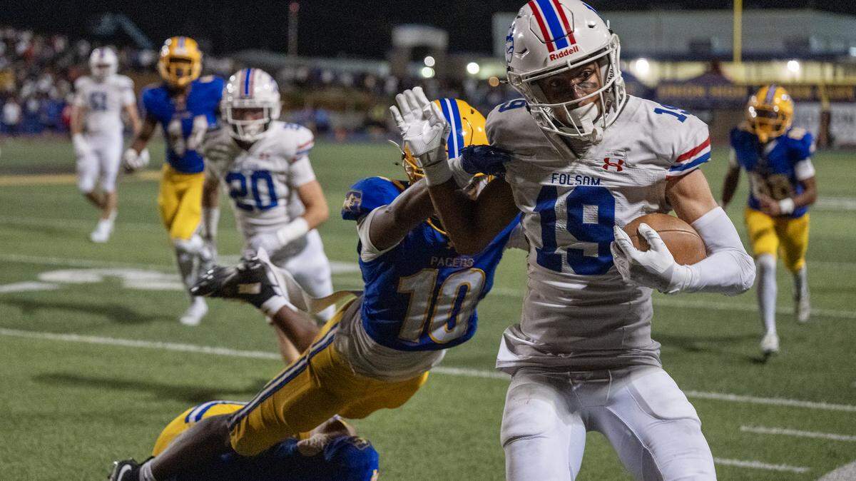 The Folsom Bulldogs’ Jason Hill Jr. (19) is pushed out of bounds by the Grant Pacers’ Jaylen Rabon (10) on Aug. 23 in Del Paso Heights.