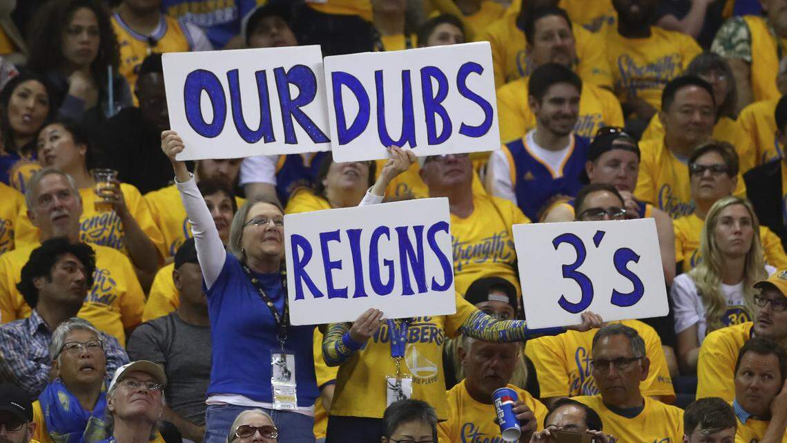 Golden State Warriors fans hold signs during the second half in Game 1 of a first-round NBA basketball playoff series against the San Antonio Spurs Saturday, April 14, 2018, in Oakland, Calif.