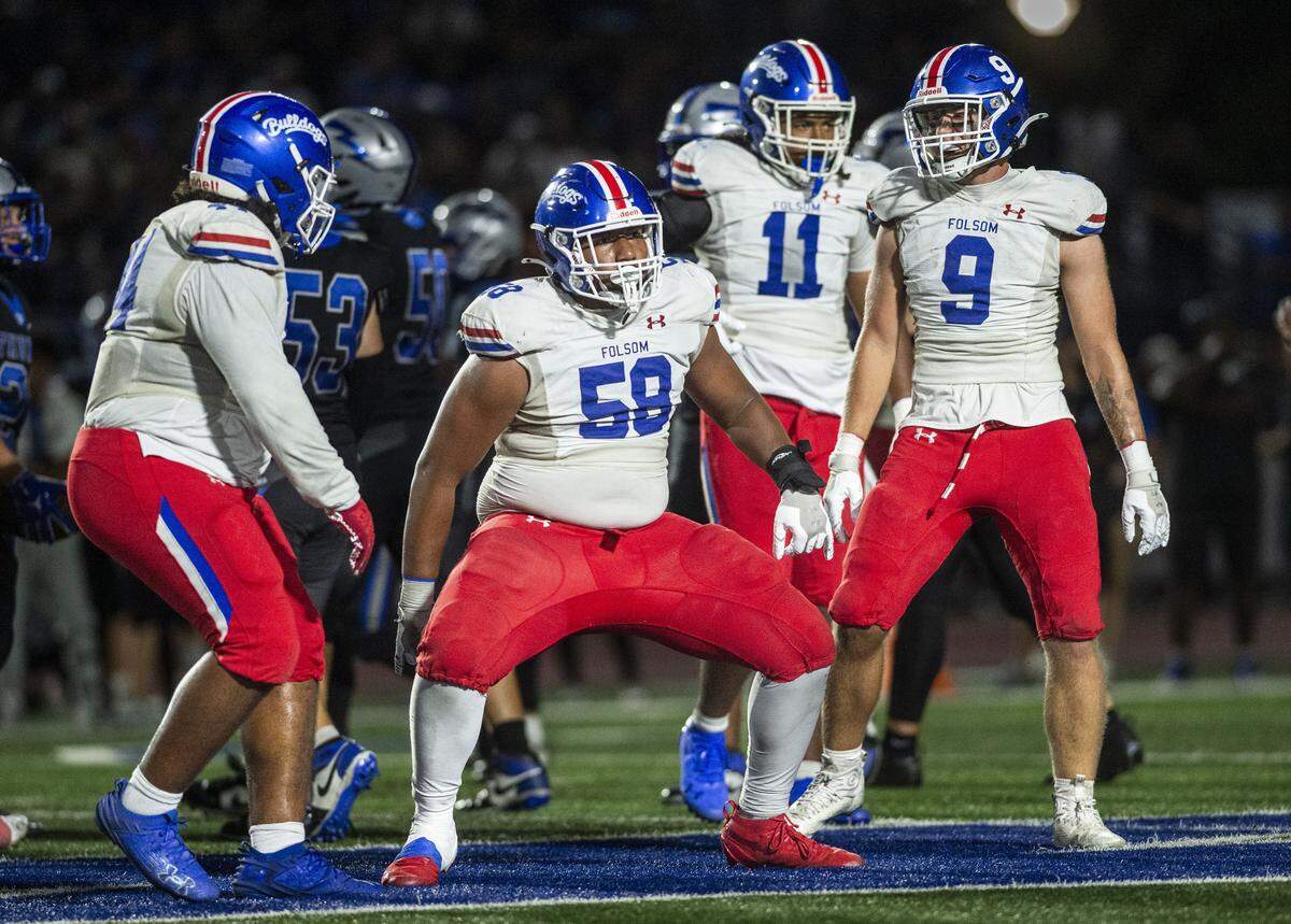 Folsom Bulldogs defender Lua Deberry (58) celebrates a sack with teammates against the Rocklin Thunder on Friday in Rocklin.