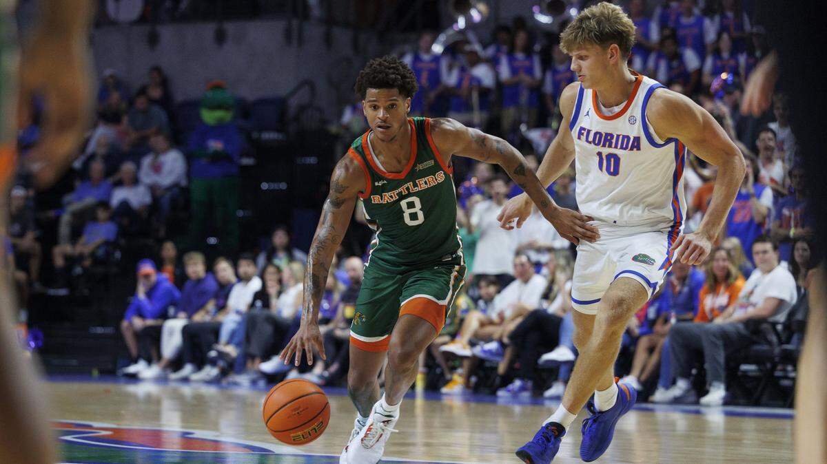 Nov 19, 2024; Gainesville, Florida, USA; Florida A&M Rattlers forward Shaqir O'Neal (8) dribbles the ball past Florida Gators forward Thomas Haugh (10) during the first half at Exactech Arena at the Stephen C. O'Connell Center. Mandatory Credit: Morgan Tencza-Imagn Images