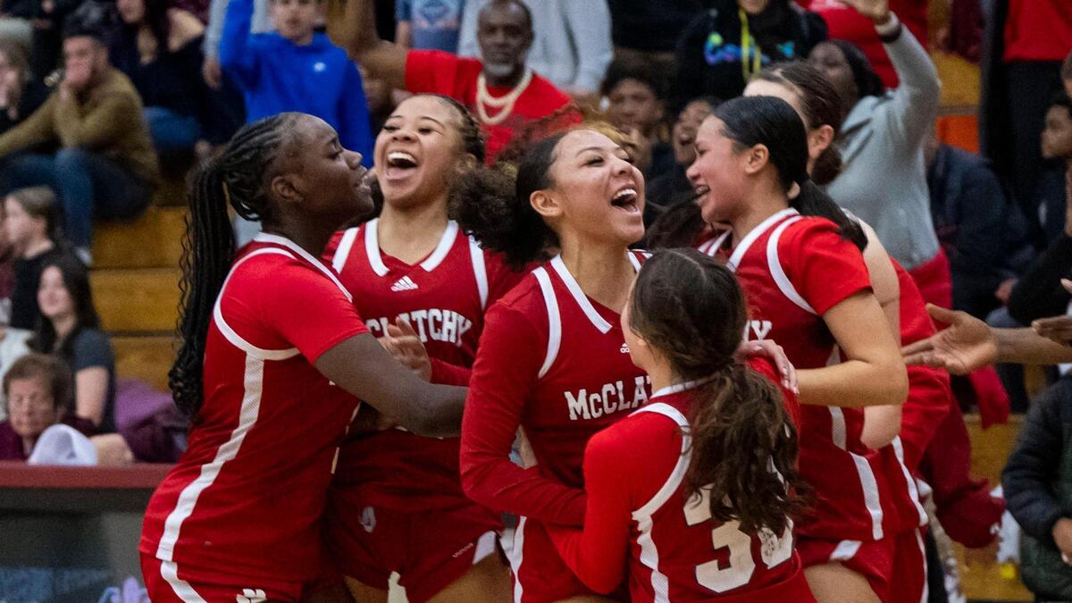 The McClatchy Lions of Sacramento celebrate their overtime win against the Whitney Wildcats of Rocklin in a CIF Northern California regional girls basketball championship quarterfinal game Thursday at Whitney High School.