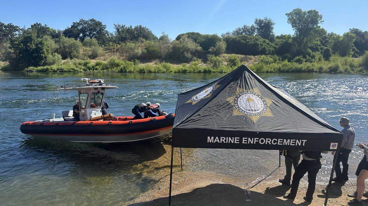 A diving team is seen coming ashore on the American River on Sunday, June 16, 2024, after they located the body of a man in his 30s who drowned. Authorities had searched for the man Saturday after he disappeared beneath the water while rafting with a large party near Rancho Cordova.