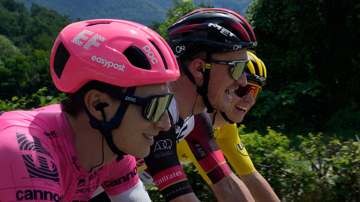 Slovenia’s Tadej Pogacar, wearing the overall leader’s yellow jersey, smiles as he talks with Roseville’s Neilson Powless, left, and Denmark’s Mikkel Bjerg, center, during the tenth stage of the Tour de France on Tuesday, July 6, 2021.
