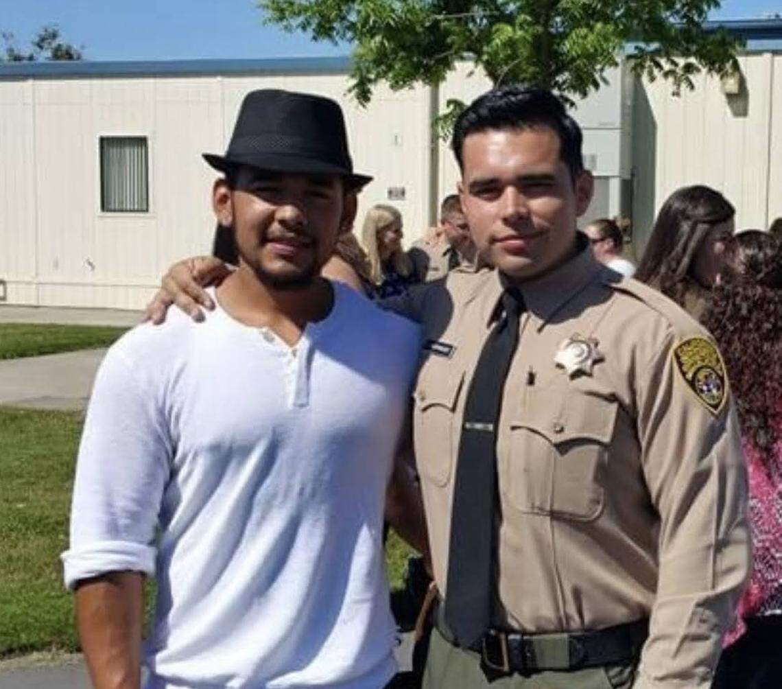 Valentino Rodriguez Jr., right, stands with his brother Gregory Rodriguez at his graduation from Basic Correctional Officer Academy in Galt in 2015.