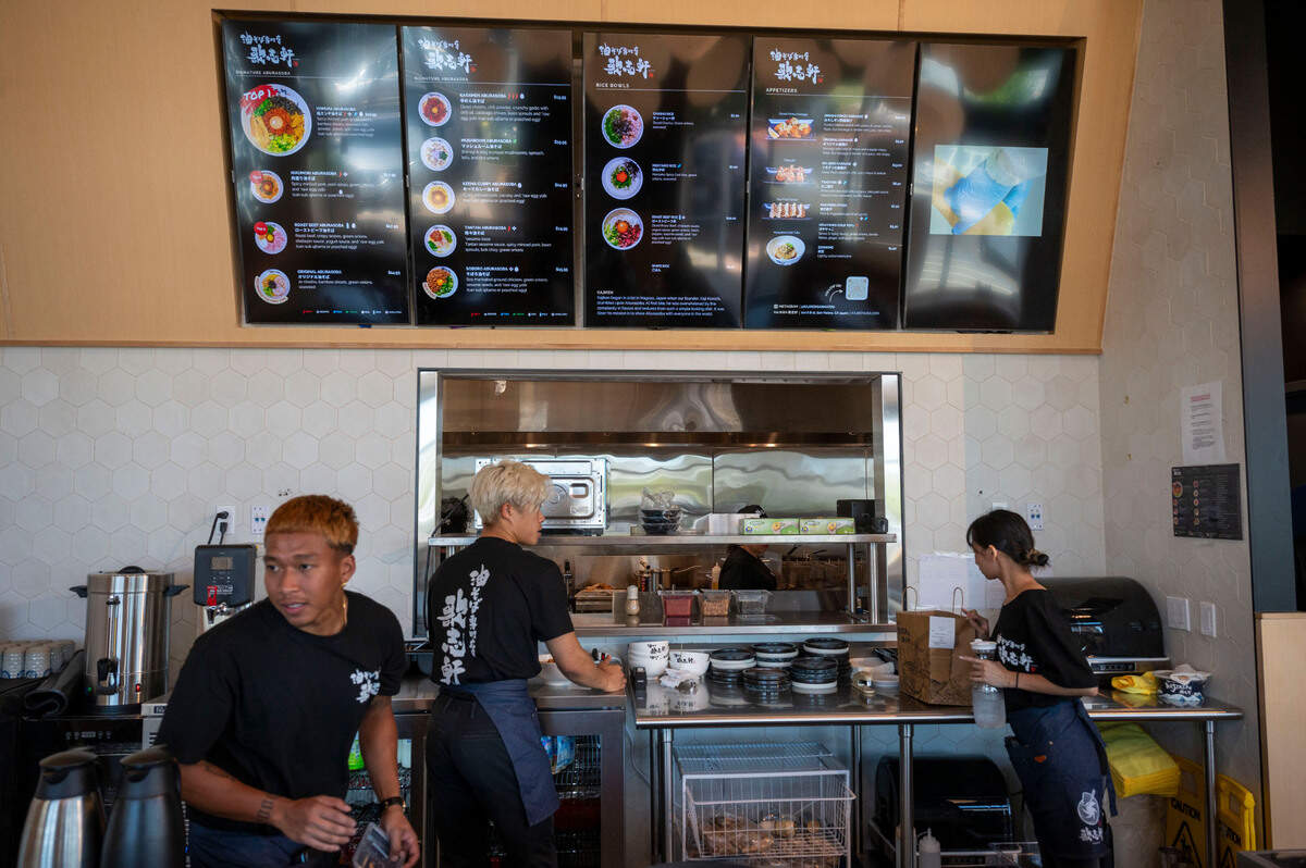 Servers work behind the counter at Kajiken in Elk Grove on thier opening day Thursday.