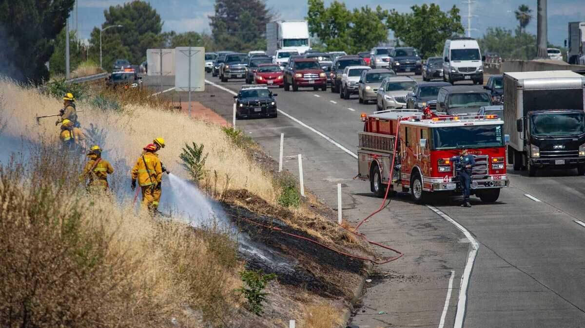 A small grass fire backs up traffic on westbound Highway 50 at the Capital City Freeway interchange, Saturday, June 13, 2020. The fire was quickly extinguished but flared up about an hour later.