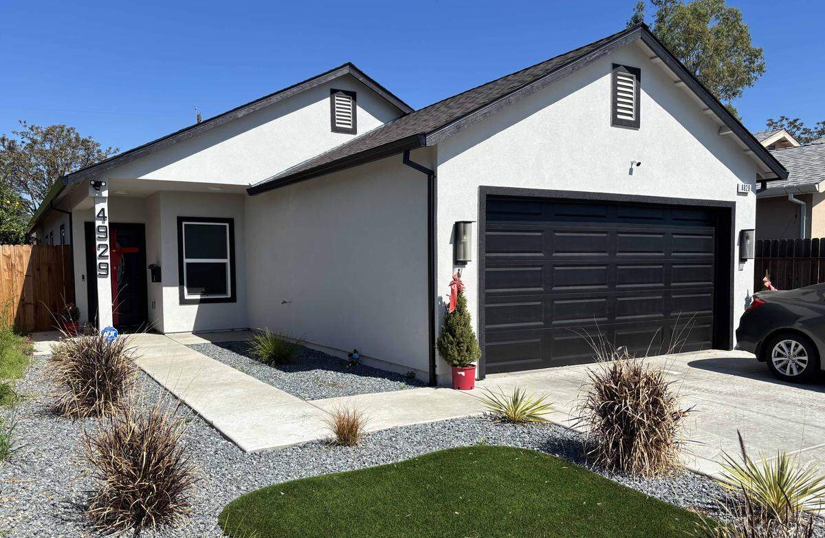 A recently constructed home, photographed in March 2026, stands at 4929 Baker Ave. in Sacramento County. The property was a vacant parcel when it was sold in a 2022 tax auction for $87,997.