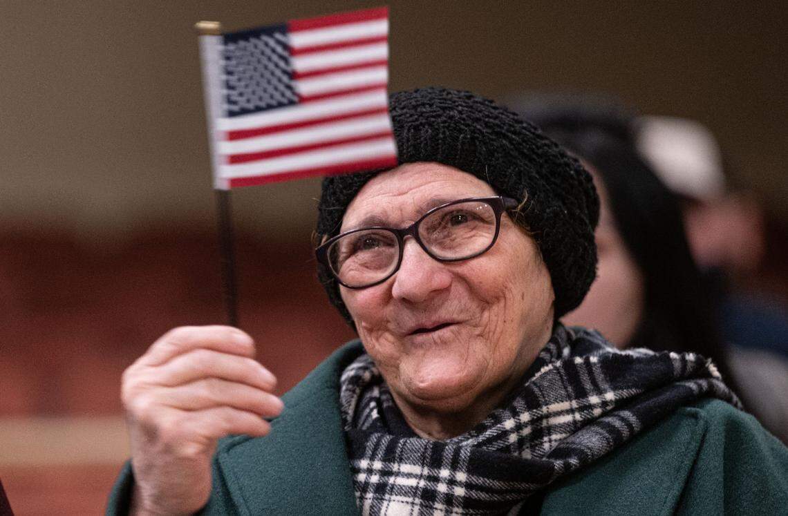 Sacramento resident Rajaa Rasool, originally from Iraq, waves an American flag after she took her oath during a naturalization ceremony with more than 800 people from around the world to become U.S. citizens on Wednesday at Memorial Auditorium in Sacramento.