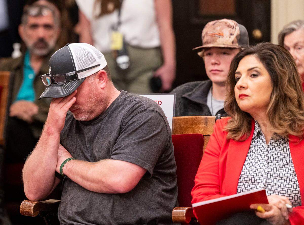 Aaron Brooks, the father of mountain lion attack victims Taylen and Wyatt Brooks, reacts as opponents speak during a hearing on Senate Bill 818 on Tuesday at the state Capitol as he sits next to the bill’s author, state Sen. Marie Alvarado-Gil, R-Jackson. Behind Brooks sits his son Wyatt, who was 18 when he was severely injured in the attack. His brother Taylen, 21, was killed.