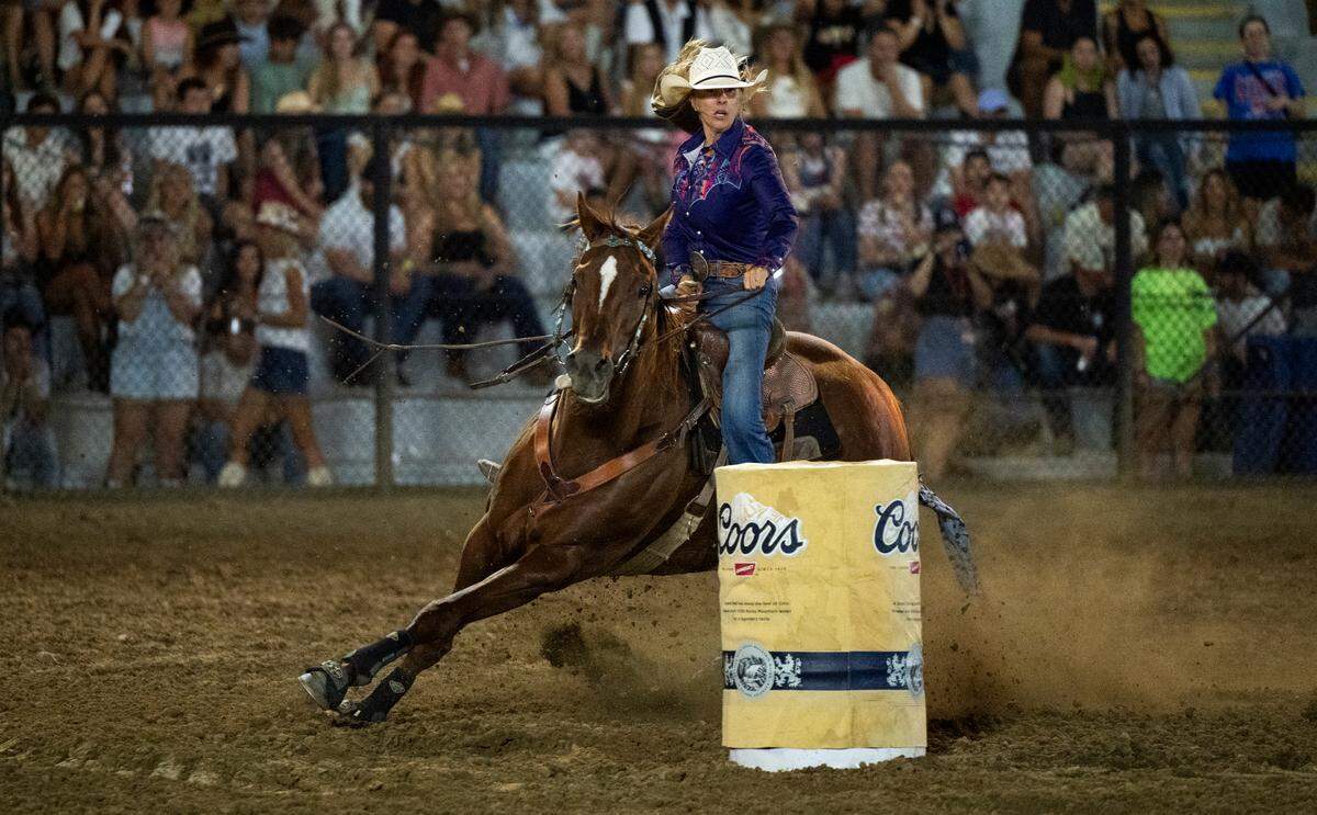 A barrel racer and her horse circle a barrel during the Folsom Pro Rodeo on Thursday.