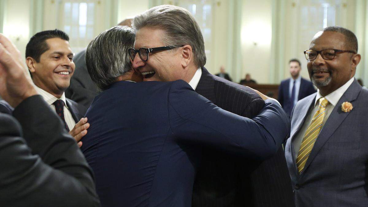 Assemblyman Rob Bonta, D-Alameda, left, and Sen. Bob Hertzberg, D-Van Nuys, celebrate Monday after the bill they co-authored to end cash bail was approved by the Assembly.