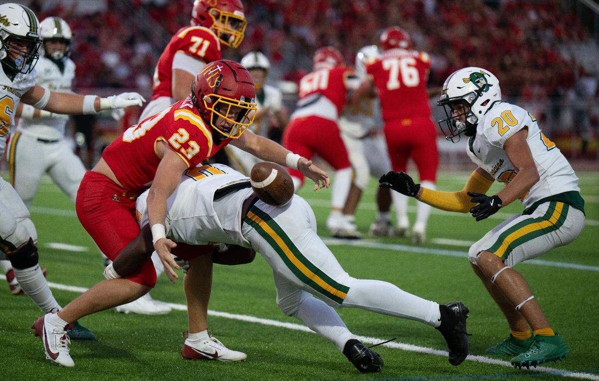 The Jesuit Marauders’ Jack Patock (23) fumbles after being hit by a Rio Americano Raiders defender on Friday at Jesuit High School in Carmichael. The Raiders’ Keegan Leary (20) recovered the ball.