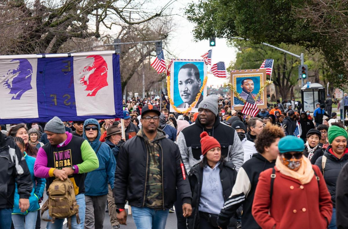 Thousands of marchers head north on Freeport Boulevard from Sacramento City College past William Land Park during the MLK365 March for the Dream honoring Martin Luther King Jr. on Monday, Jan. 16, 2023, in Sacramento. The main march began and ended at the college in what MLK365 founder Sam Starks called a “love loop” that also included Land Park Drive and Broadway.