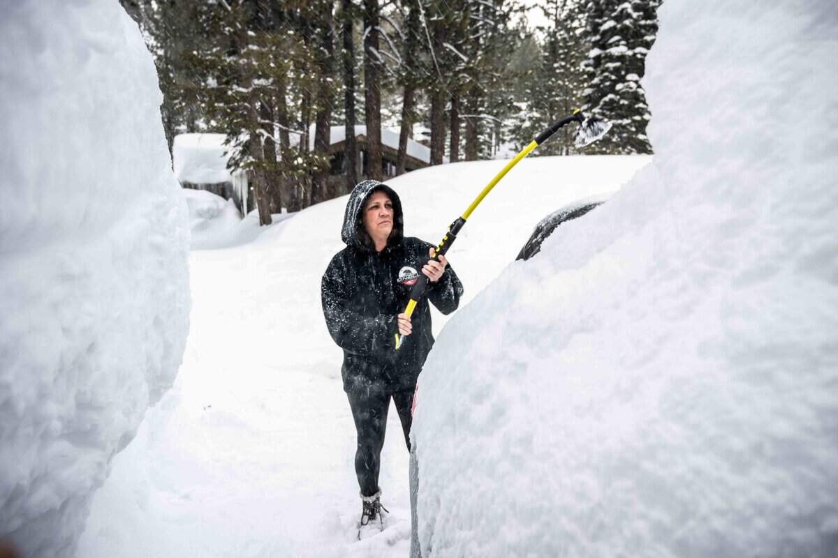 Erika Travillion of South Lake Tahoe removes snow from her car on Monday, March 6, 2023 in El Dorado County.