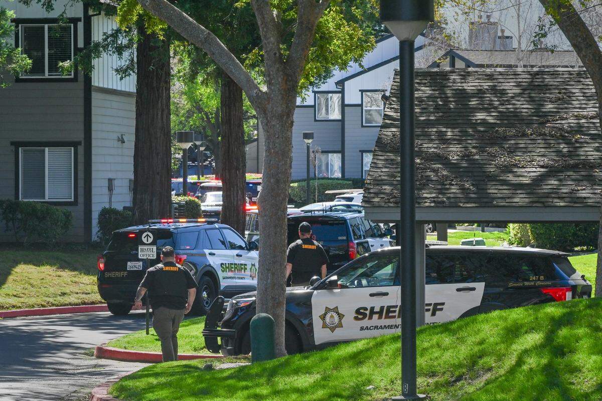 Officers arrive on the scene after gunfire erupted at the Hazel Ranch apartment complex in the 8800 block of Winding Way in Fair Oaks on Friday.