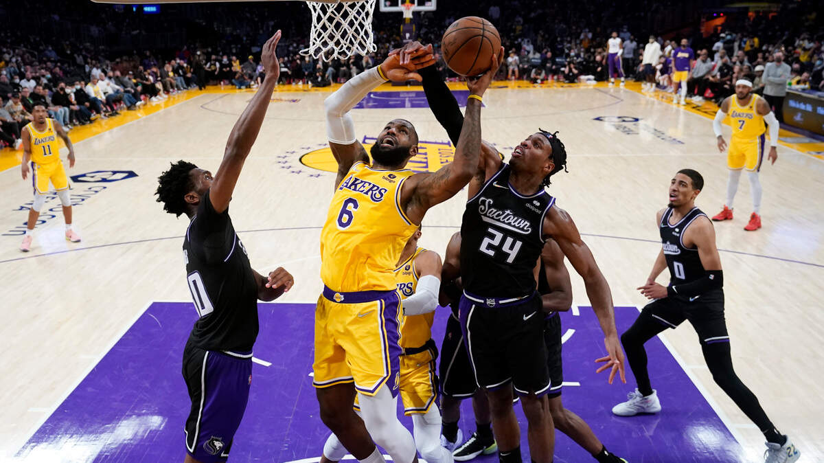 Los Angeles Lakers forward LeBron James (6) drives to the basket as Sacramento Kings guard Buddy Hield (24) defends during the second half of an NBA basketball game Tuesday, Jan. 4, 2022, in Los Angeles. (AP Photo/Marcio Jose Sanchez)