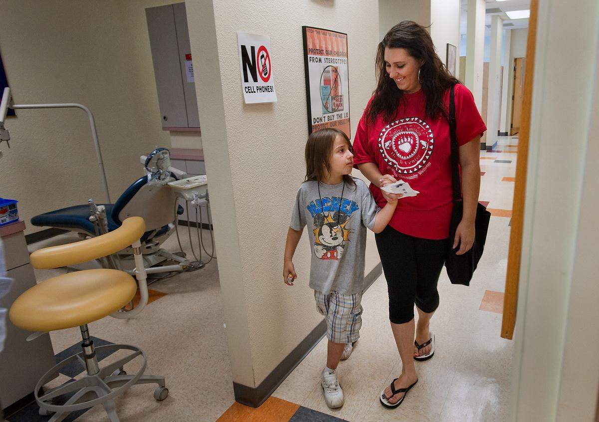 Dental patient Michael Hunsaker 7, left, and his mother Emma Snuggs (cq) at the Sacramento Native American Health Center, Inc. in Sacramento in June 2010.