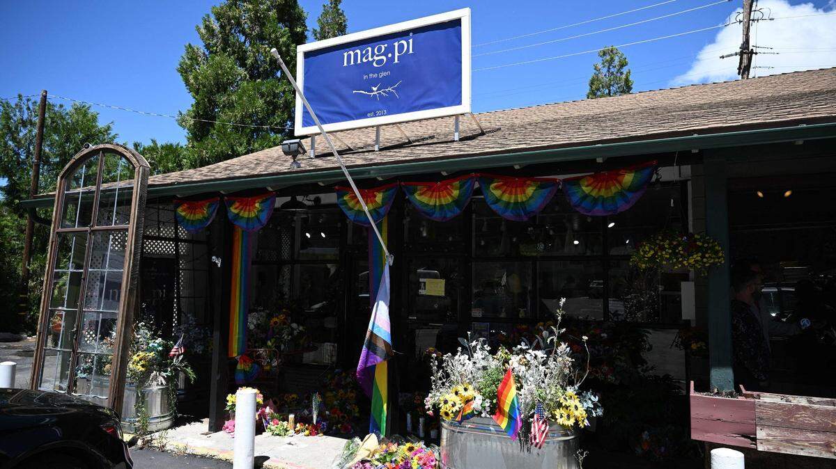 A Pride flag ripped off its flag pole is seen outside the entrance to the Mag.Pi clothing store in Cedar Glen, near Lake Arrowhead, California, on Monday, Aug. 21, 2023. The owner of the store, Laura Ann Carleton, was fatally shot on days before by a man who made “disparaging remarks about a rainbow flag” displayed outside her store, according to the San Bernardino County Sheriff’s Department. The suspect was later killed during an encounter with deputies.