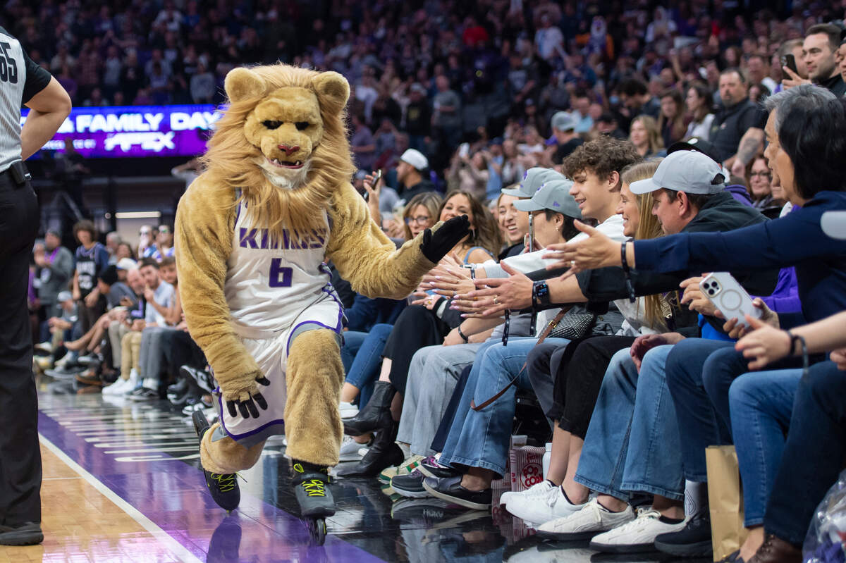 Slamson the Lion high-fives fans on the sidelines as he roller blades past them during a timeout in the second half of the NBA basketball game at Golden 1 Center last year.