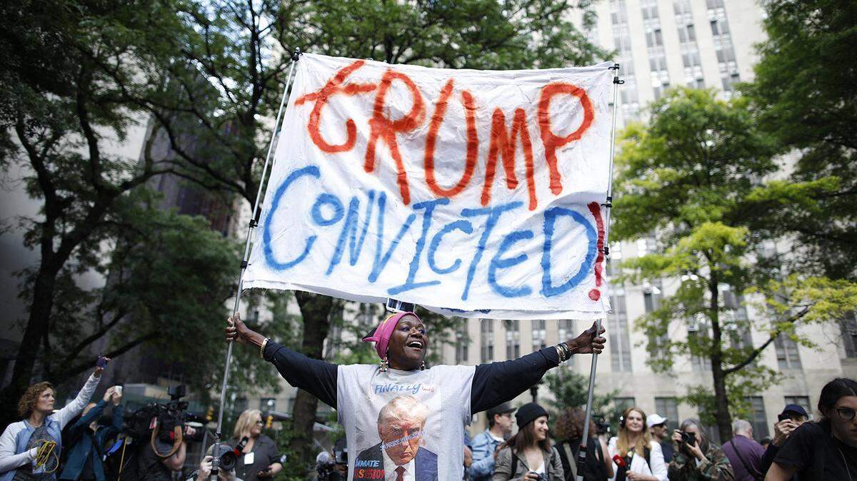 People react after former President and Republican presidential candidate Donald Trump was convicted in his criminal trial, outside of Manhattan Criminal Court in New York City on May 30, 2024. The jury convicted Donald Trump on all 34 charges.
