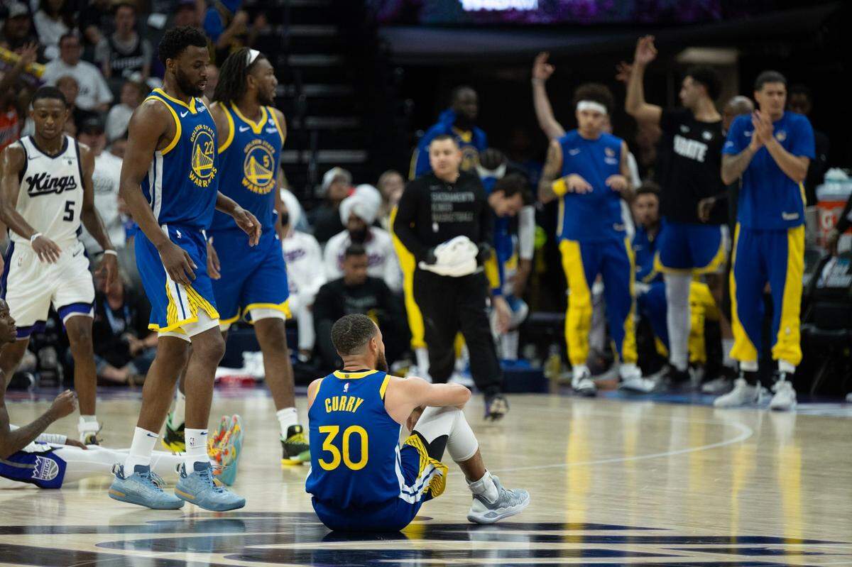 Golden State Warriors guard Stephen Curry (30) sits on the court after a broken play against the Sacramento Kings at Golden 1 Center on Tuesday.
