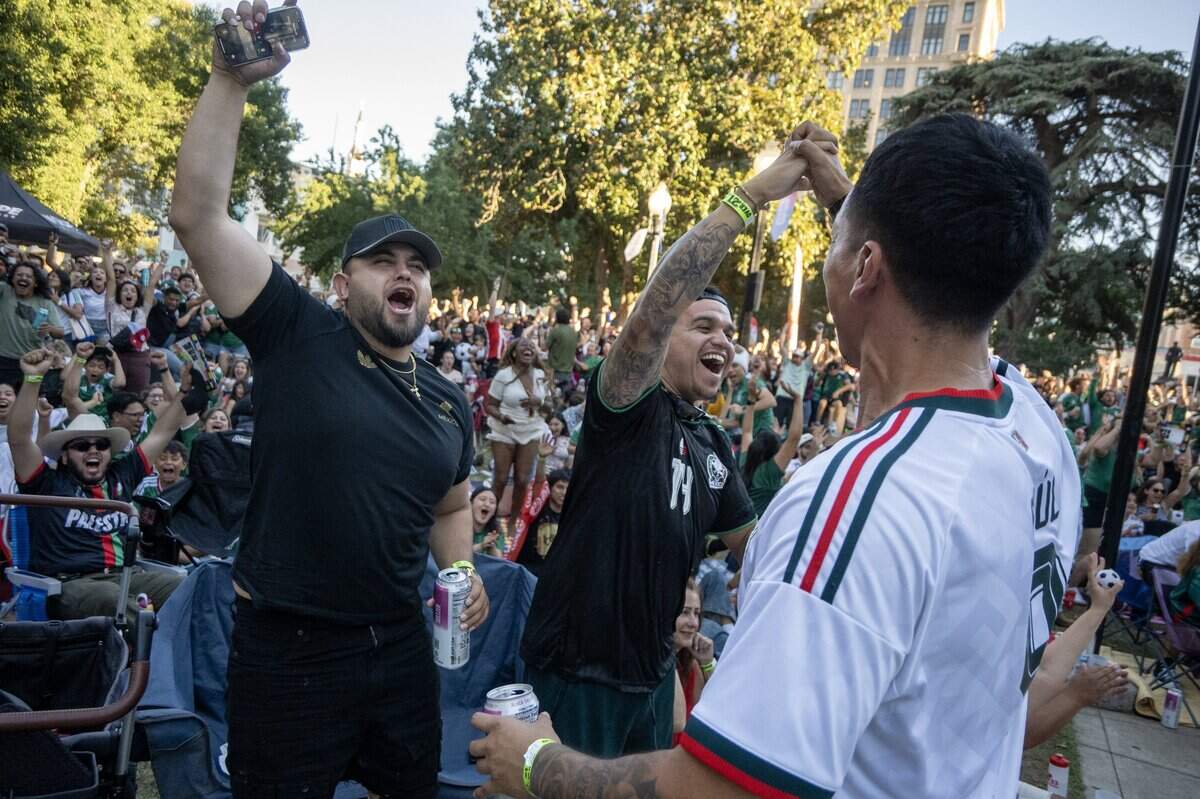 Mexico fans Mauricio Gomez, left, Jesus Guerrero and Pablo España celebrate Mexico's first goal against Czechia during Sacramento Republic FC's World Cup block party at the park across from City Hall in downtown Sacramento on Wednesday, June 24, 2026.