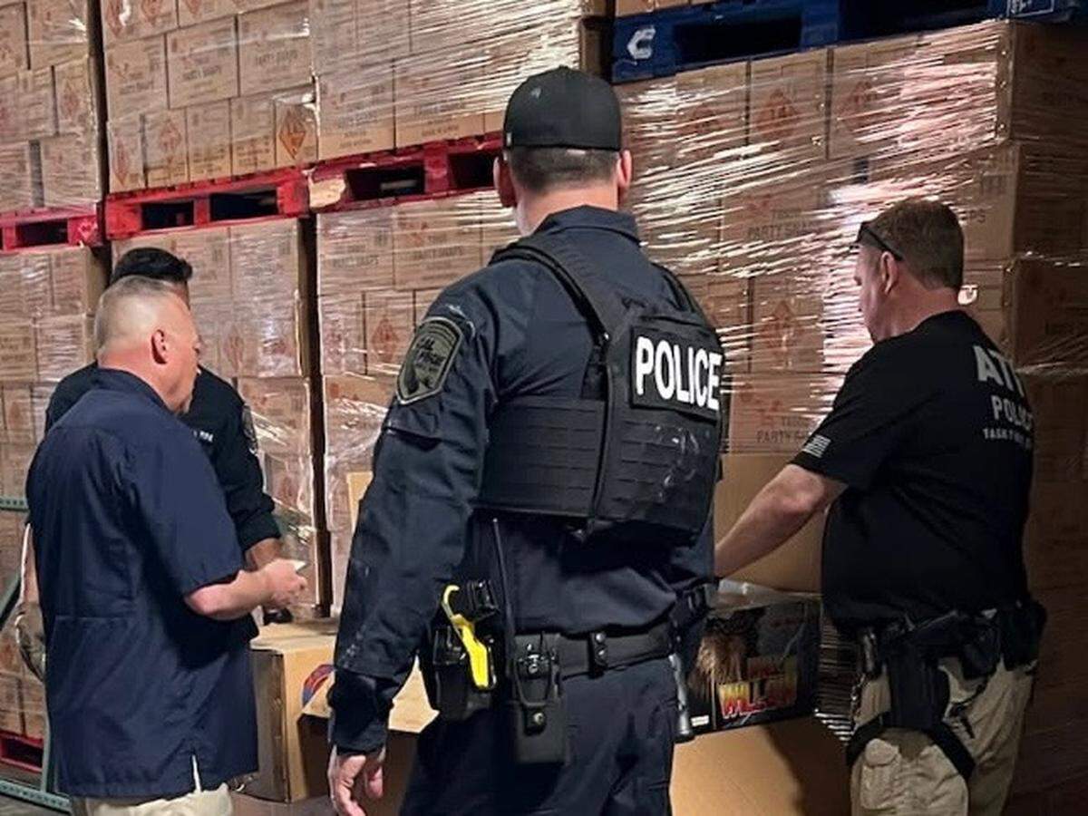 Officers from Cal Fire and the Bureau of Alcohol, Tobacco, Firearms and Explosives stand by seized fireworks in Commerce California on May 21, 2025. Over 100,000 pounds of illegal fireworks were seized during the raid. The owner of the warehouse business alleges that the illegal firework belonged to Kenneth Chee, the owner of Devastating Pyrotechnics, which is tied to deadly explosions which killed seven workers on July 1, 2025, in Esparto.
