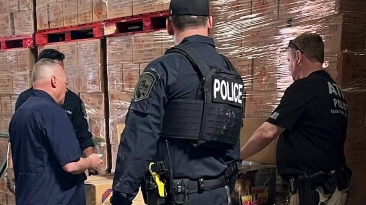 Officers from Cal Fire and the Bureau of Alcohol, Tobacco, Firearms and Explosives stand by seized fireworks in Commerce California on May 21, 2025. Over 100,000 pounds of illegal fireworks were seized during the raid. The owner of the warehouse business alleges that the illegal firework belonged to Kenneth Chee, the owner of Devastating Pyrotechnics, which is tied to deadly explosions which killed seven workers on July 1, 2025, in Esparto.