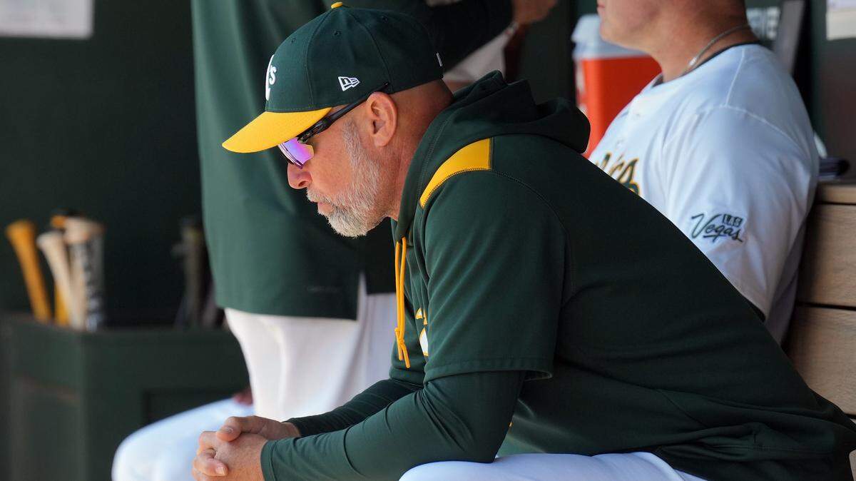Apr 9, 2025; West Sacramento, California, USA; Athletics manager Mark Kotsay (7) sits in the dugout before the game against the San Diego Padres at Sutter Health Park. Mandatory Credit: Darren Yamashita-Imagn Images