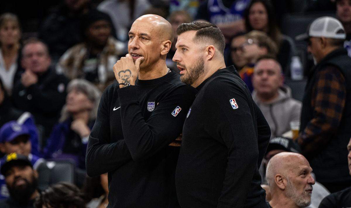 Sacramento Kings interim coach Doug Christie talks with assistant Luke Loucks against the Dallas Mavericks at Golden 1 Center on Monday.