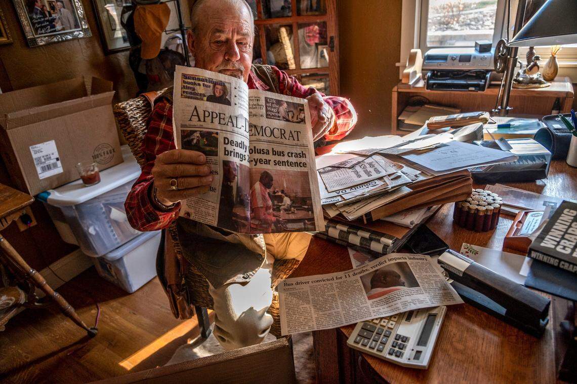 Retired Colusa County district attorney John Poyner, who prosecuted Quinton Watts, unfolds a newspaper in his home office on Dec. 10 that shows Watts’ sentencing in 2009. “It was a sad case,” Poyner said.
