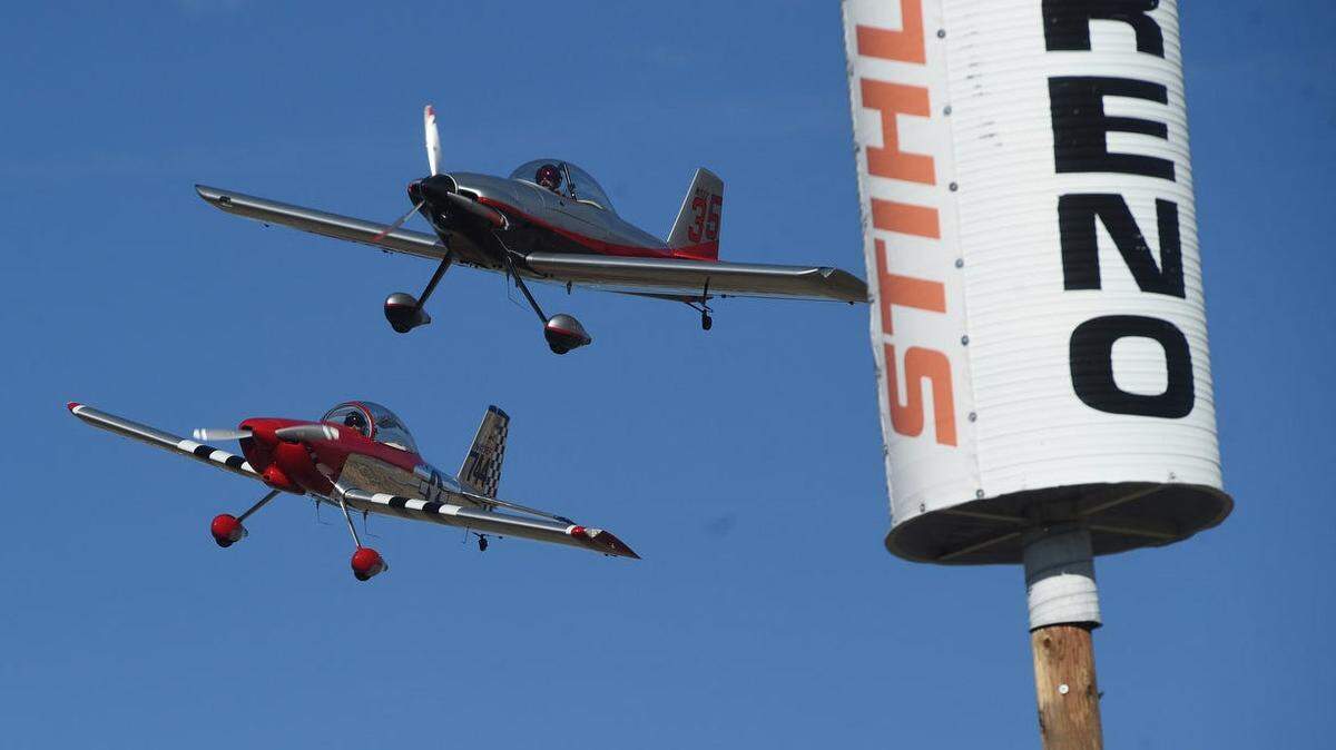 Two planes race during the Reno National Championship Air Races in 2021 at Reno-Stead Airport in Nevada. The Reno Air Racing Association confirmed two pilots died Sunday in a collision at the races.