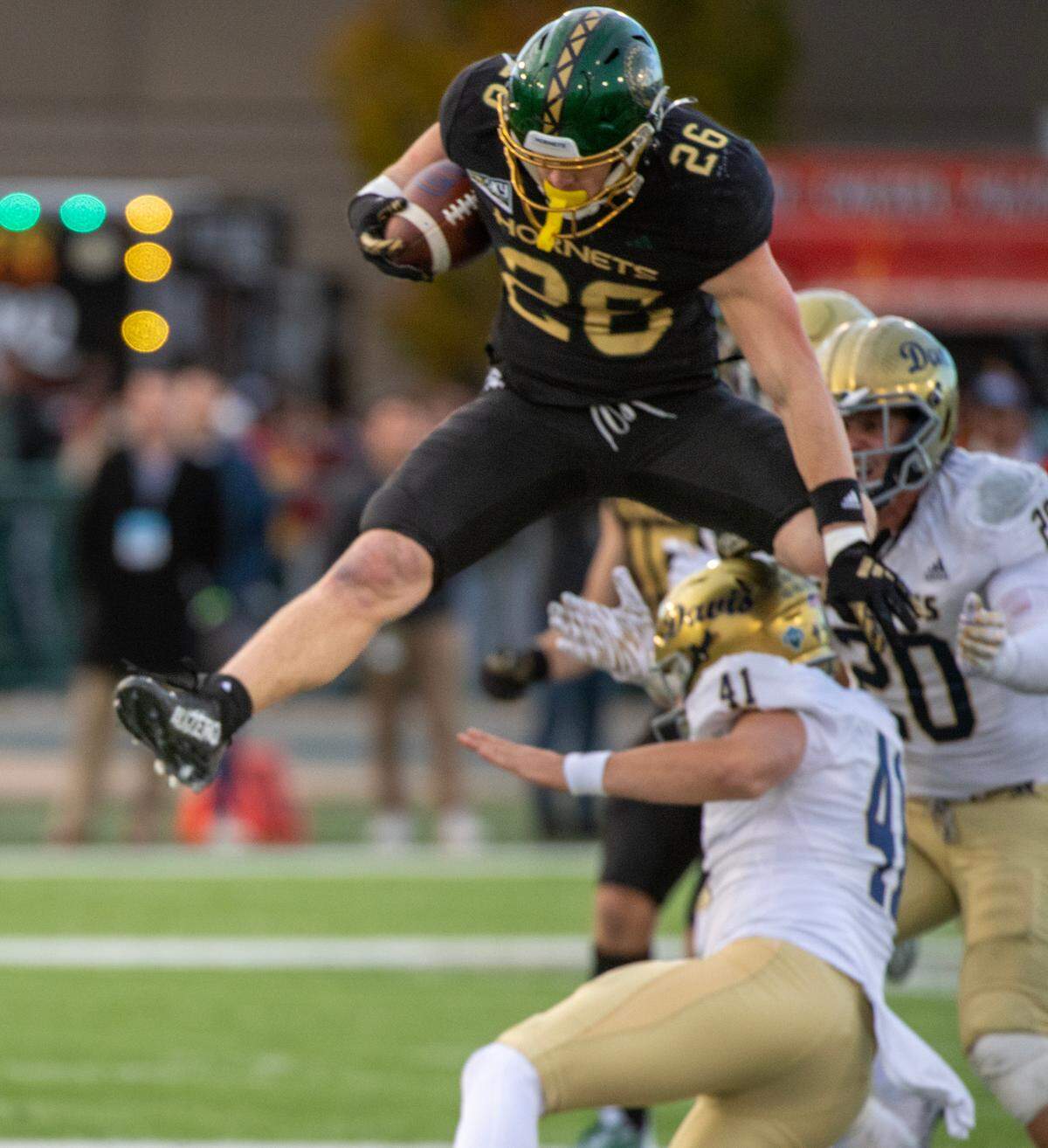Sacramento State Hornets Anderson Grover (26) hurdles UC Davis Aggies place kicker Ben Banks-Altekruse (41) as he returns a punt in the second half of the 70th Causeway Classic on Saturday in Sacramento.