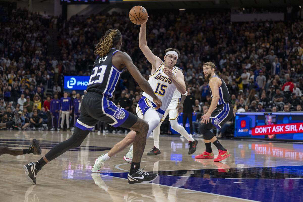 Los Angeles Lakers guard Austin Reaves (15) drives to the basket as Sacramento Kings guard Keon Ellis (23) defends him, getting his sixth foul, during an NBA game at Golden 1 Center on Sunday.