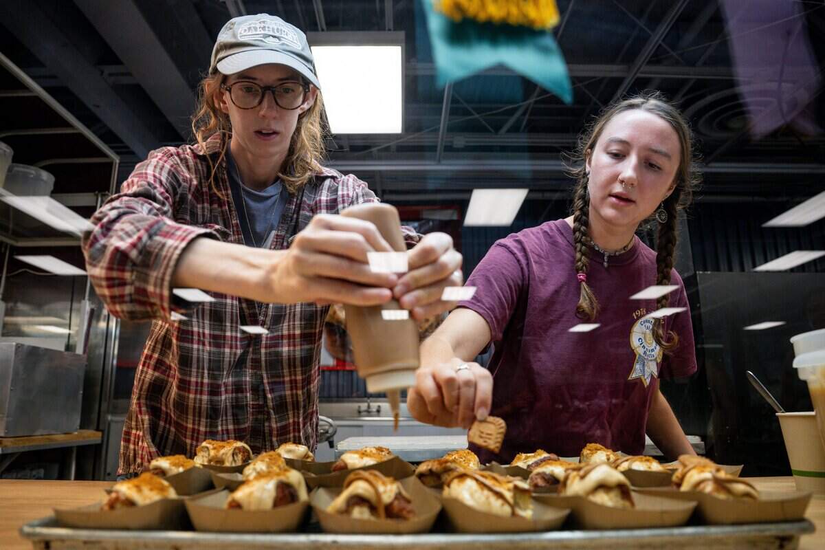 Janice Madaus, left, and Abigail Madaus of Country Fair Cinnamon Rolls prepare desserts during the California State Fair media day on Cal Expo in Sacramento on Wednesday, July 15, 2026.