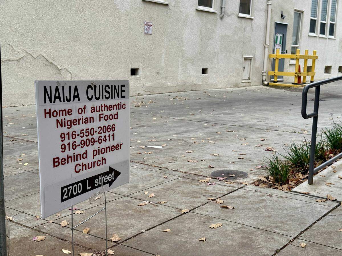 The sign for Naija Cuisine points to a door in the back of Pioneer Church at 2700 L Street in midtown.