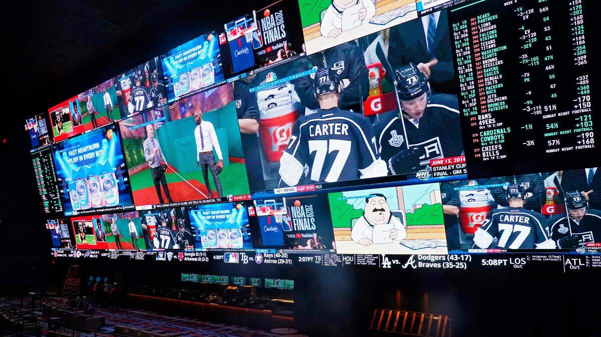 In this Oct. 2020 file photo, screens show sports and betting odds in the sports book at the Circa Resort & Casino in Las Vegas. (AP Photo/John Locher)