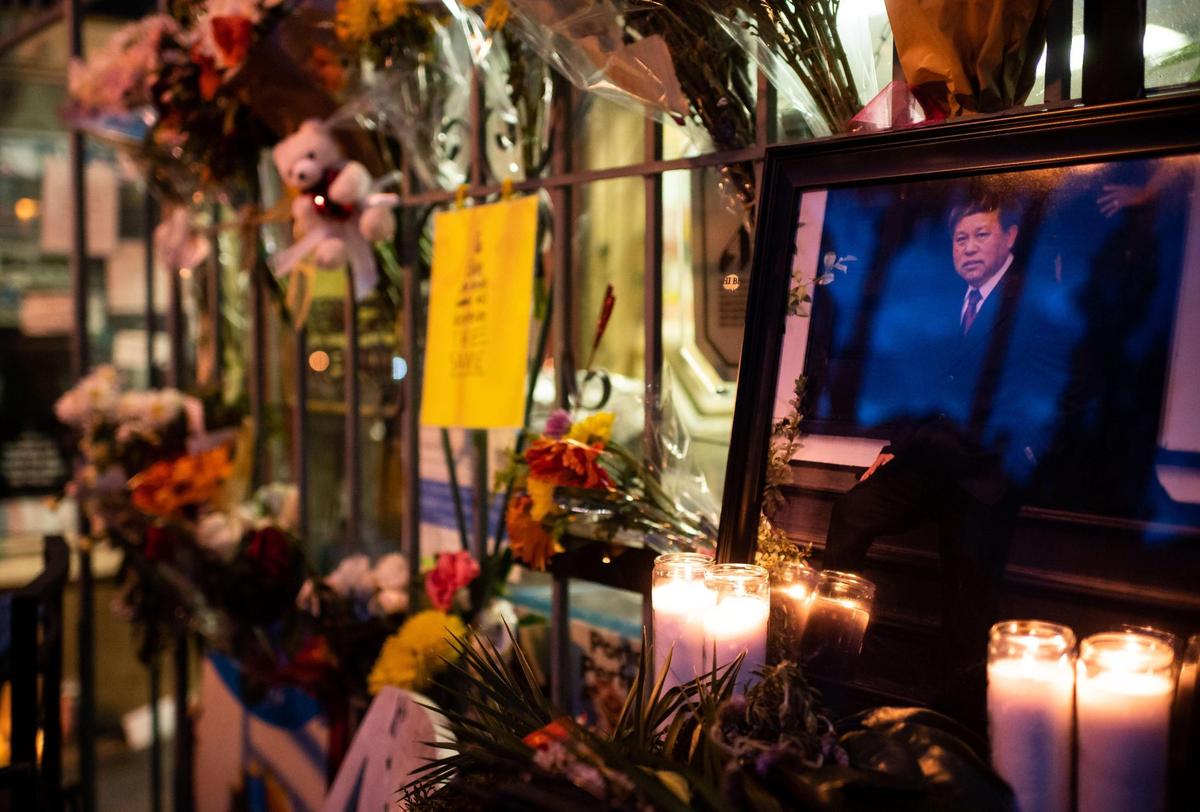 A framed photograph of Chue “Calvin” Yang, owner of DJ Market, is surrounded by flowers and candles during a vigil held in his honor Saturday, Jan. 30, 2021, at the I Street store in Sacramento. Yang died suddenly at his store Tuesday.
