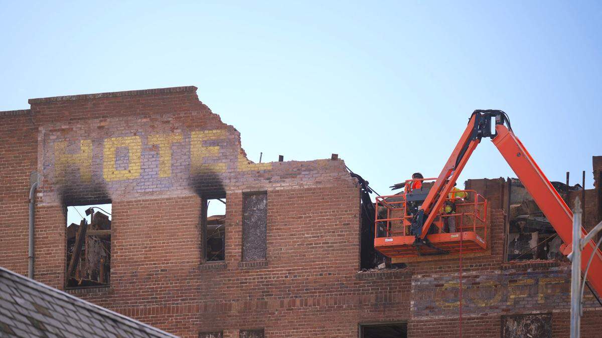Construction workers remove the top layer of freestanding bricks at the Hotel Marysville on Thursday before the demolition begins next week.