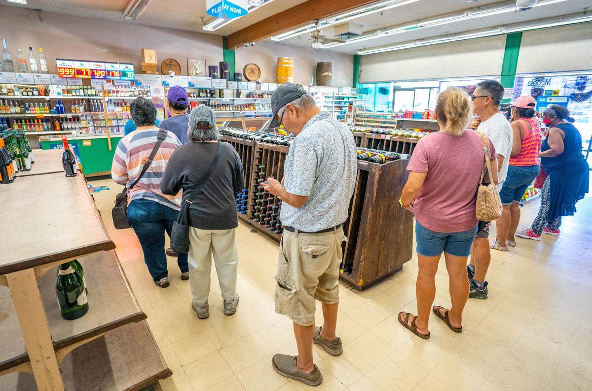 Lichine’s Liquor & Deli has a line filled with customers waiting to pick up lottery tickets, Wednesday, July 19, 2023.