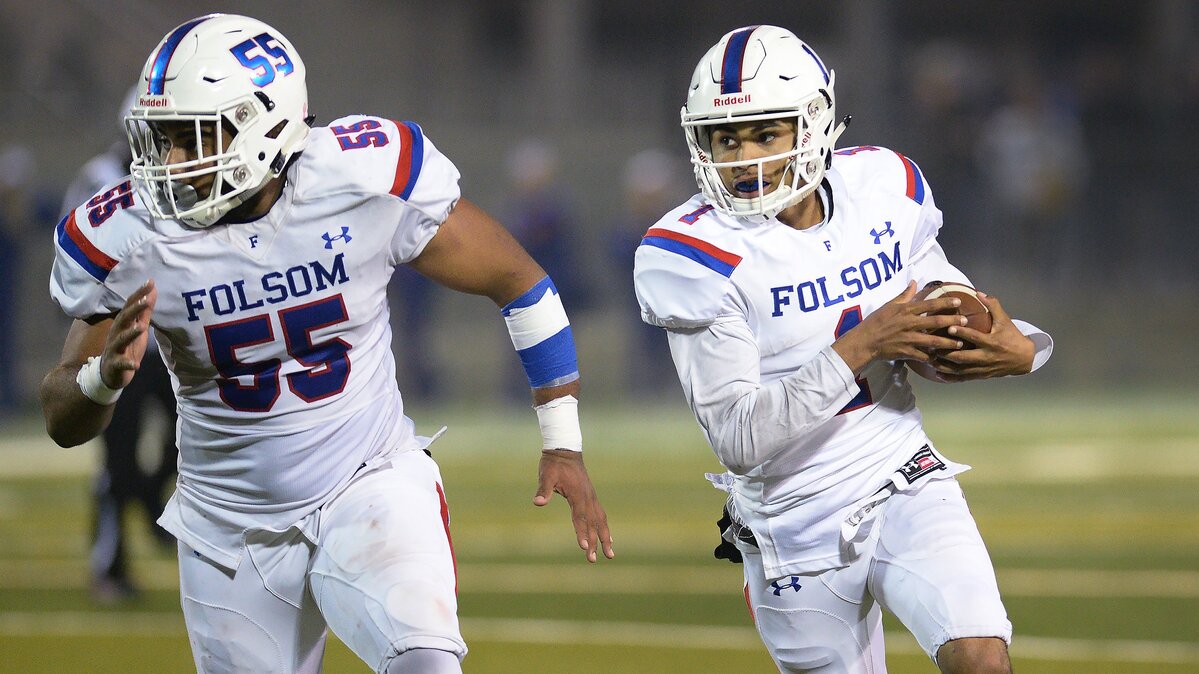 Folsom quarterback Kaiden Bennett, right, gets blocking help from teammate Logan Harrison while taking the ball on a keeper during their NorCal Regional Division 1 championship game against Central High at Koligian Stadium in Fresno on Friday, Dec. 7, 2018.