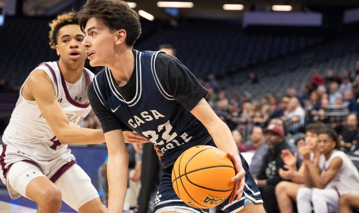 Casa Roble Rams guard Benny Ambriz (22) dribbles past a Natomas Nighthawks defender in the first half of the CIF Sac-Joaquin Section Division IV boys basketball section championship at Golden 1 Center on Feb. 27.