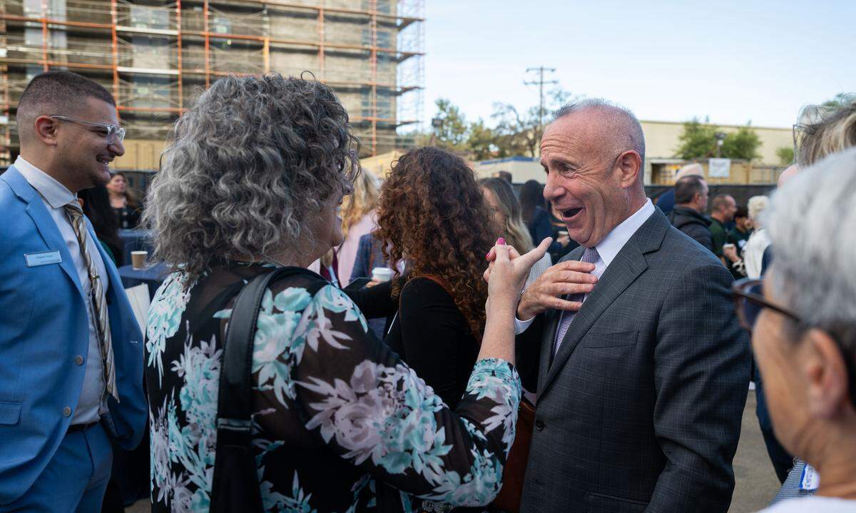 Julie Steinberg, left, laughs with Sacramento Mayor Darrell Steinberg before she adjusted his tie as he prepared to deliver his final State of the City address on Thursday.