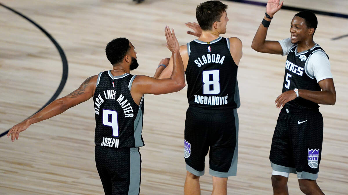 Sacramento Kings’ Cory Joseph (9), Bogdan Bogdanovic (8) and De’Aaron Fox (5) react during the second half of an NBA basketball game against the New Orleans Pelicans Thursday, Aug. 6, 2020 in Lake Buena Vista, Fla. (AP Photo/Ashley Landis, Pool)