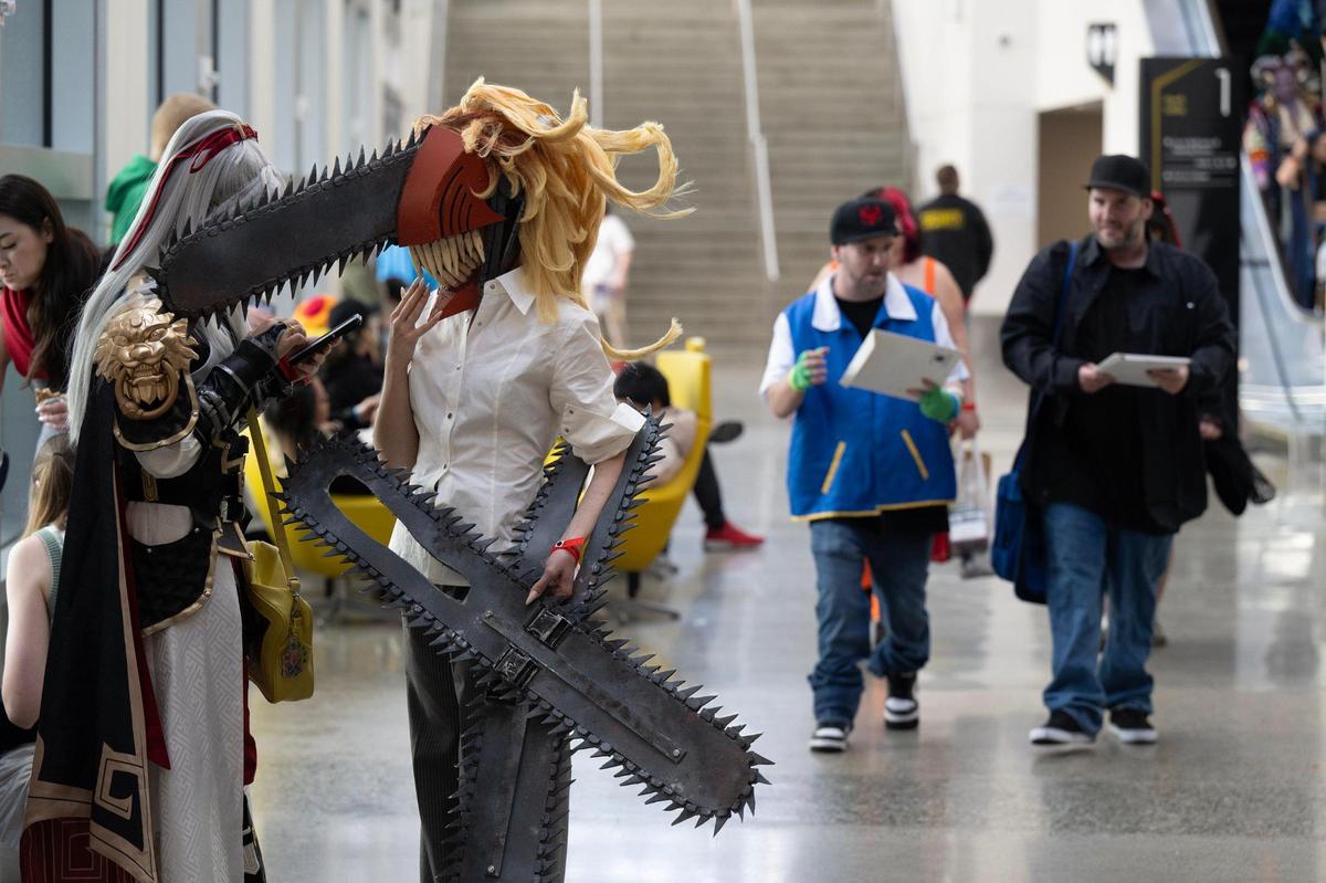Kenny Mackey, dressed as a character from the Chainsaw Man manga series, stands with Grayson Quinn, wearing a costume from Honkai: Star Rail video game, attend SacAnime on Saturday, Jan. 4, 2025, at the Sacramento convention center.