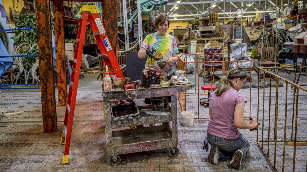 Maeve Morgan, left, and Sidalcea Burmester, right, work on painting props for Newsies at the Broadway at Music Circus warehouse on Tuesday June 27, 2018 in Sacramento.